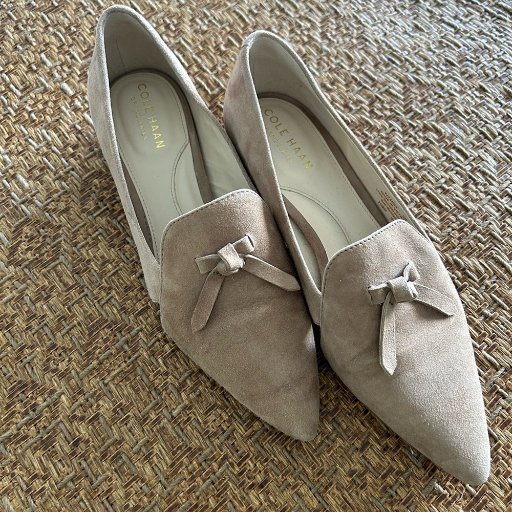 Cole Haan suede flats with cut outs and knot features.